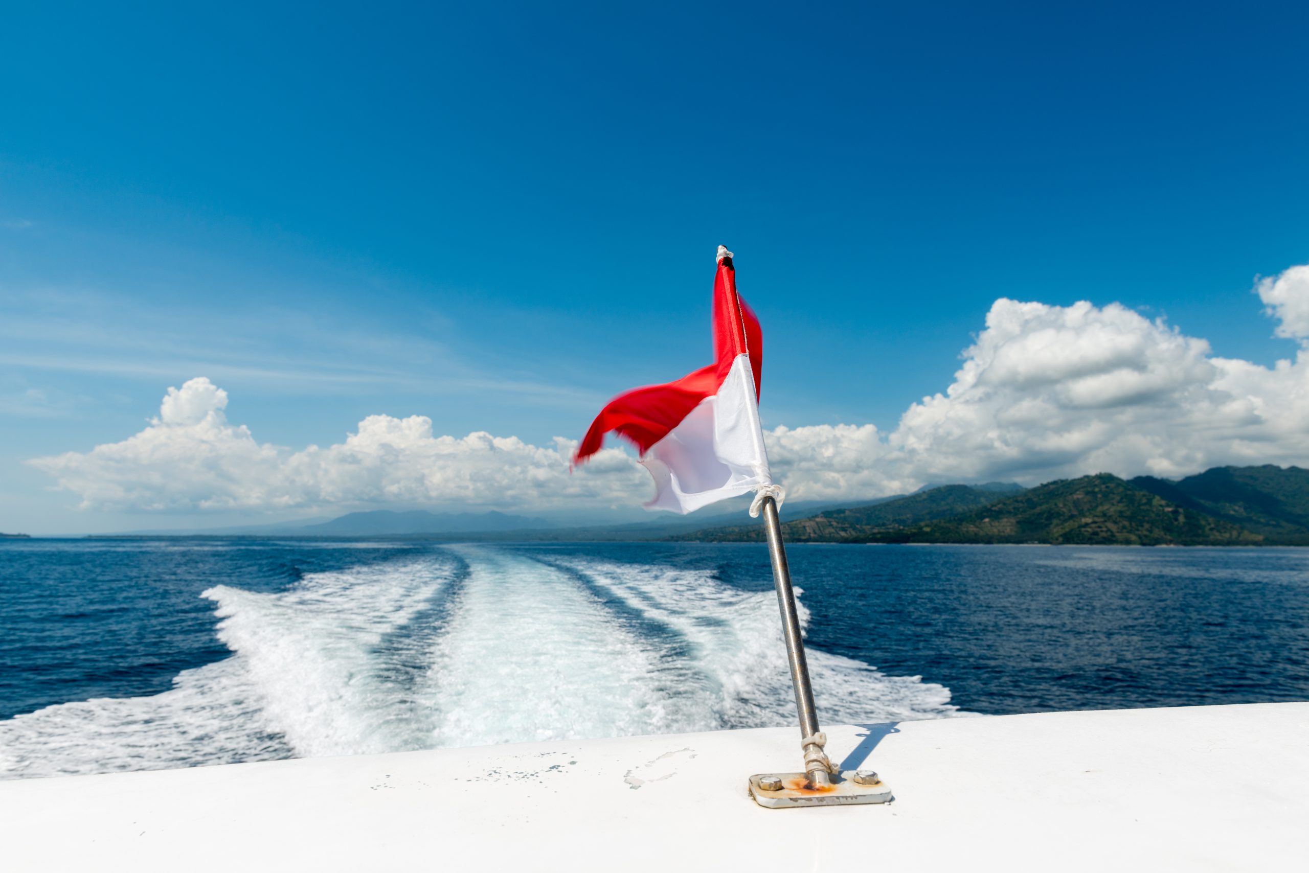Wake of a speedboat on the ocean - island hopping at Bali, Indonesia